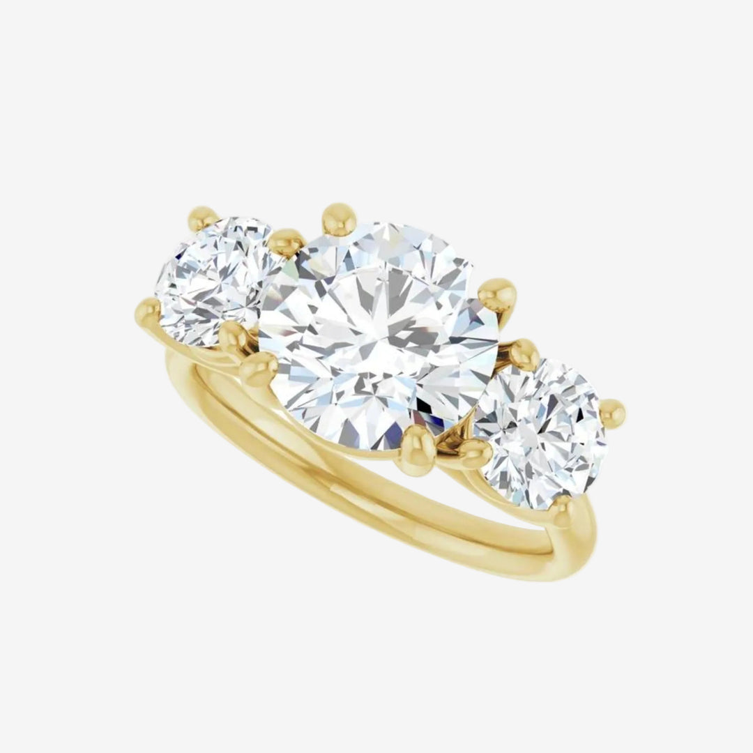 Gold ring with three round lab grown diamond on a white background