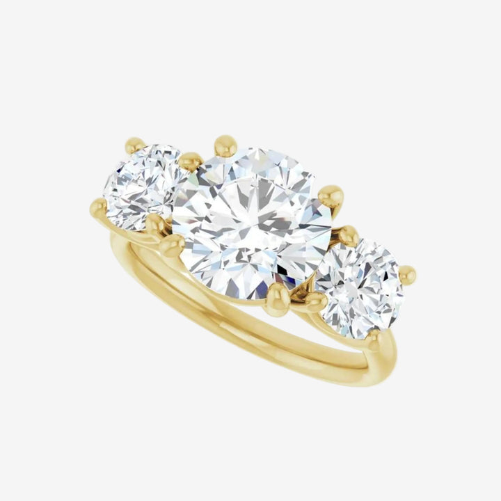 Gold ring with three round lab grown diamond on a white background