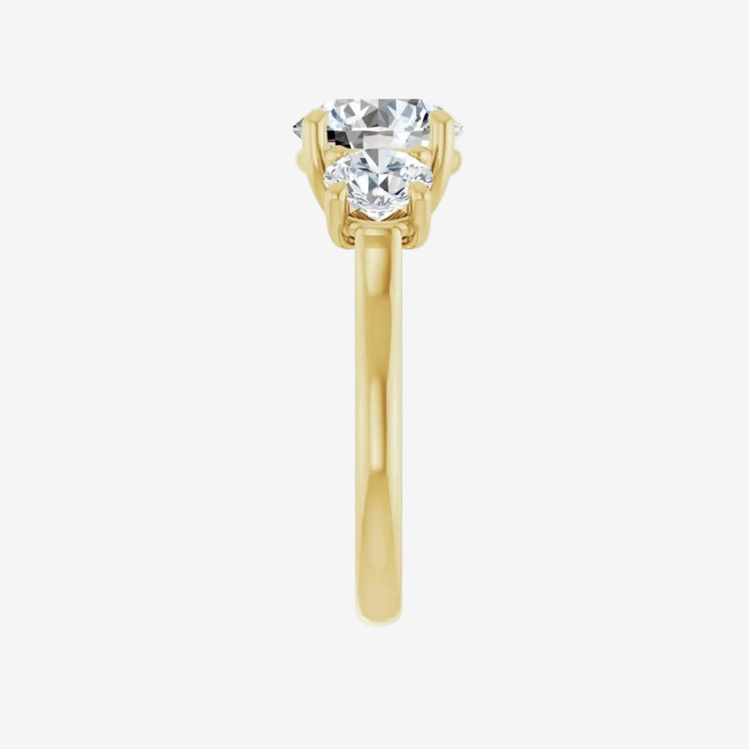 Gold ring with three round lab grown diamond on a white background