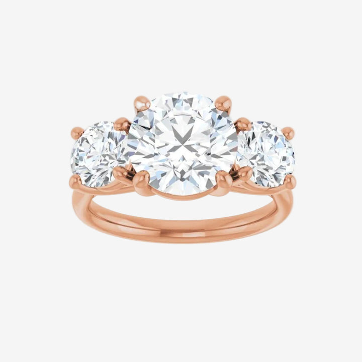 Rose gold ring with three round lab grown diamond on a white background