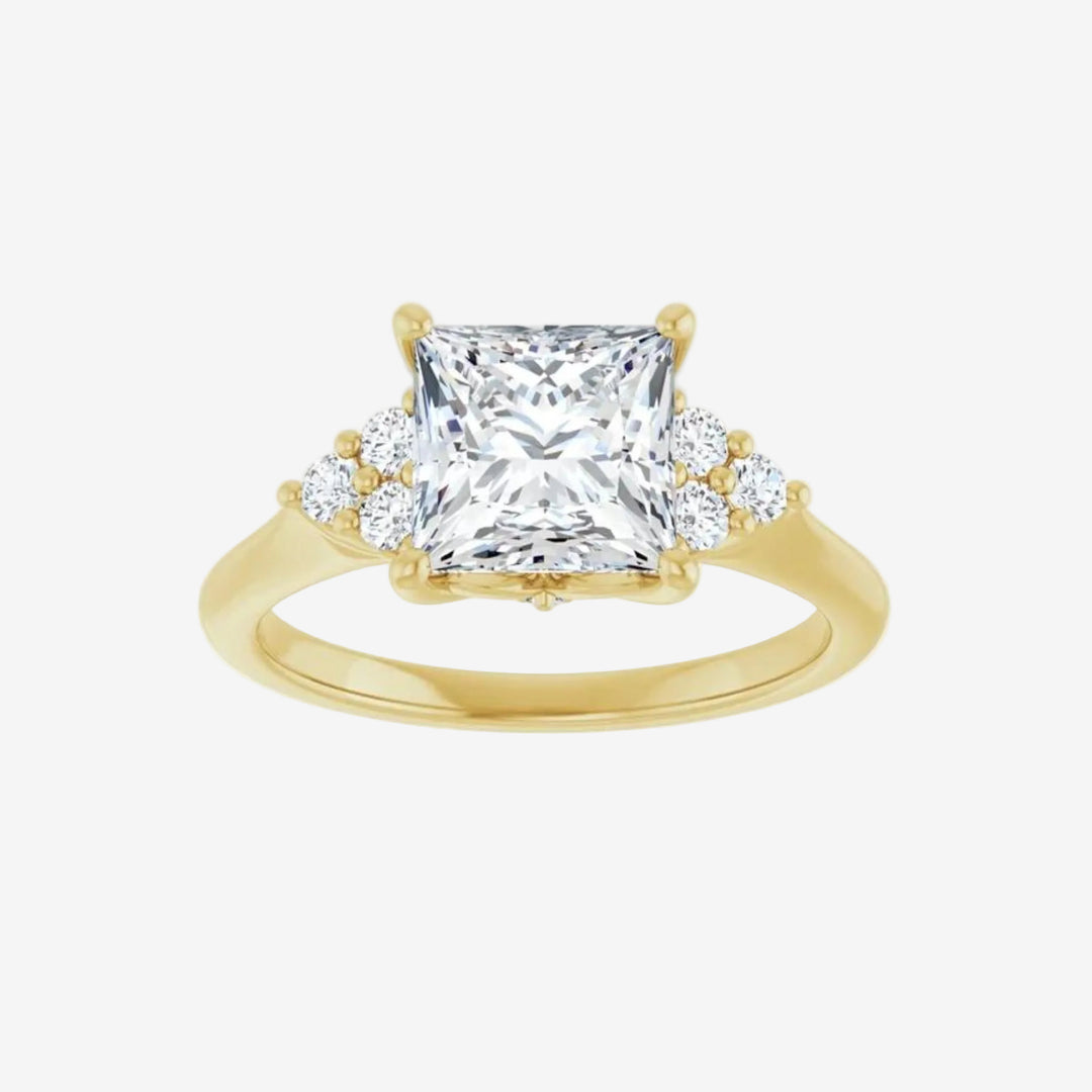 Gold ring with a large central diamond and smaller diamonds on the sides against.