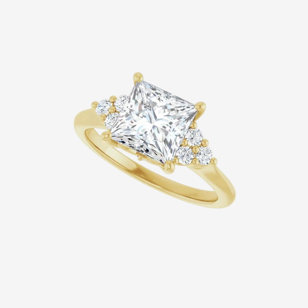 Gold ring with a large square diamond and smaller stones on the sides.