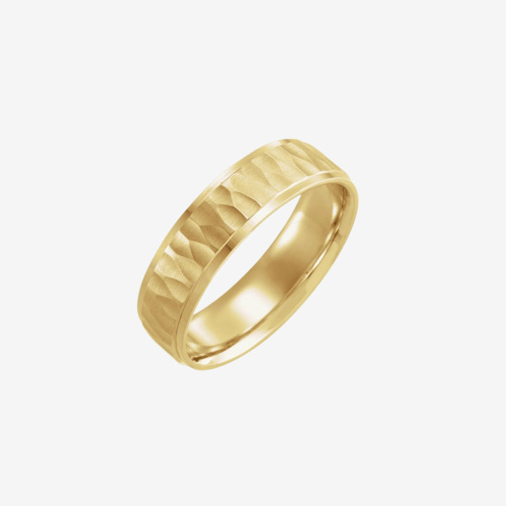 A gold ring with a hammered matte texture finish.